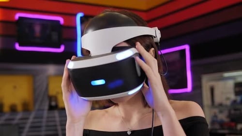Woman Using VR Headset in Neon-Lit Environment