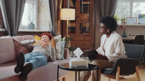 Upset Woman Lying on Couch during Therapy Session