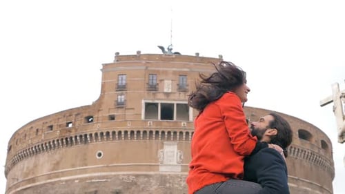 Romantic Couple Kissing Before Ancient Building