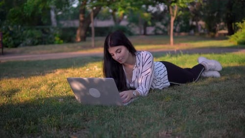 Attractive Woman Working with Laptop on Grass in Park Distance Remote Work