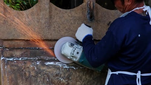 Professional men wearing goggles and construction gloves work in home workshop.