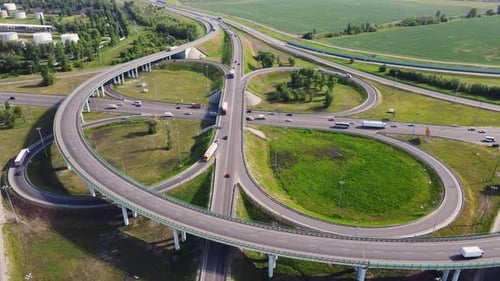 Aerial view of road interchange or highway intersection with busy urban traffic