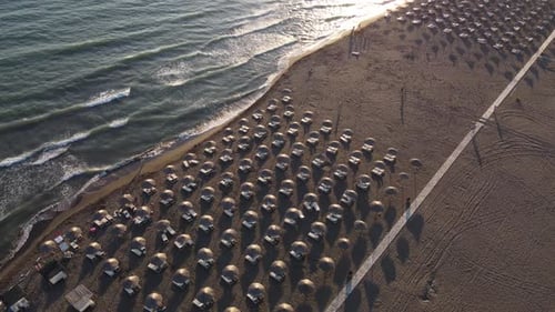 Aerial view Top view of Beautiful sea sandy beach with umbrellas and waves crashing against sand