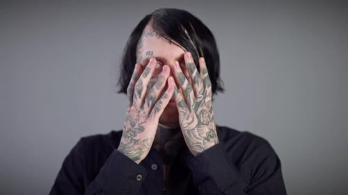 Tattooed Adult Reveals Face