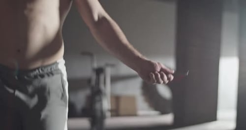 Fit Sportsman Jumping Rope in Gym