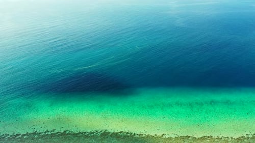 Aerial flying over texture of tropical island beach holiday by transparent sea with white sand backg