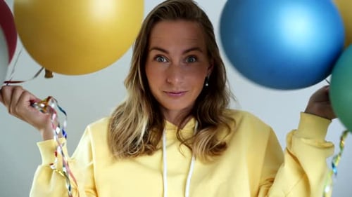 Excited Woman with Balloons Celebrates Birthday