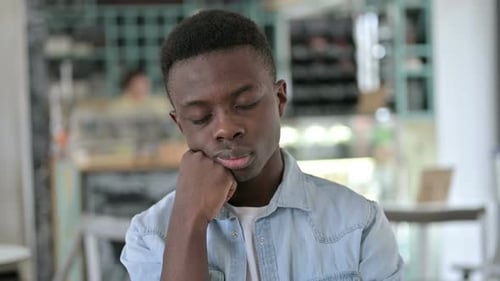 Portrait of Sleepy Young African Man Taking Nap