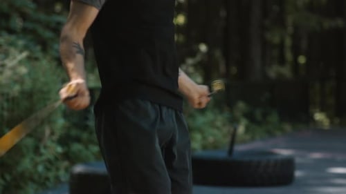 Young Fit Man Jump Rope in Green City Park