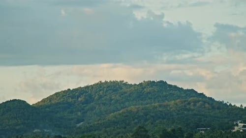 Clouds Move Over the Mountains on the Island During Sunset
