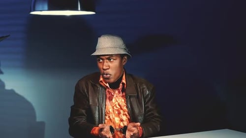 Man In Cuffs Talking at Table