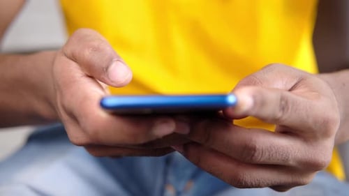Close Up of Young Man Hand Using Smart Phone