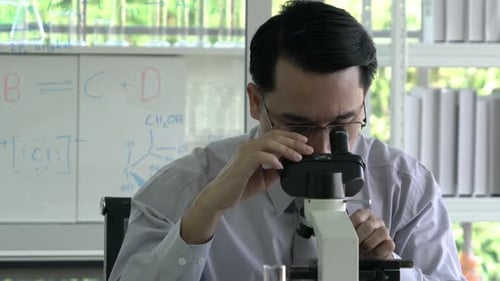 Scientist man looking microscope