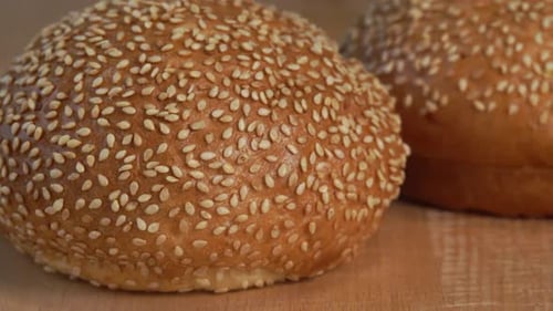Sesame Seed Hamburger Buns on Wooden Surface