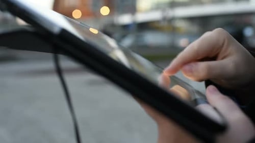 Close up hands of young woman using tablet handhold