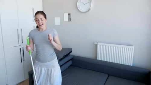 Woman Dancing with Mop in Bright Living Room