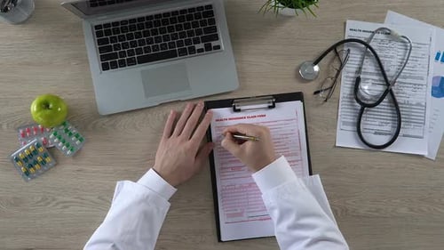 Physician Filling Patients Personal Information in Health Insurance Claim Form