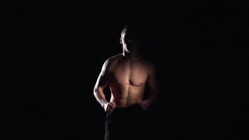 Shirtless Man Runs in Place on Black Background
