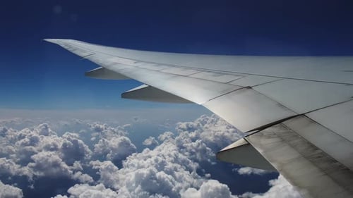 Wing of the Plane and Clouds View From the Plane