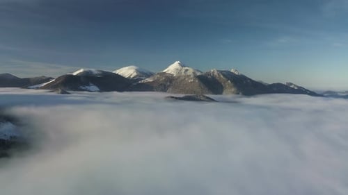Snowy Mountains Emerging from a Sea of Fog