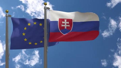 European Union and Slovakia Flags Waving Together in Blue Sky