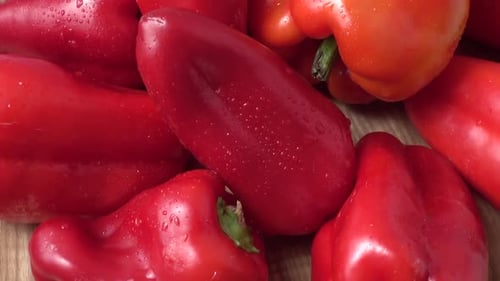 Fresh Red Bell Peppers on Cutting Board Close Up