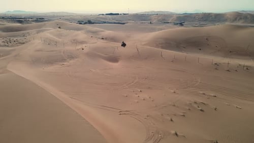 ATV Rider on Sand Dunes in Desert Landscape