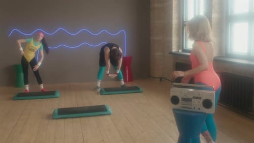 Retro Aerobics Class Exercising in 80s Style