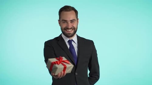 Smiling Man in Suit Offers Wrapped Birthday Gift