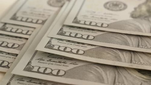 Many 100 dollar banknotes on table slow tilt 4K 2160p 30fps UltraHD footage - Close-up rows of