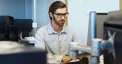 Man Working at Computer in Bright Office Setting