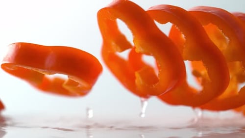 Sliced Red Bell Pepper Falling in Slow Motion