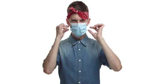 Young Adult Man Removes Face Mask