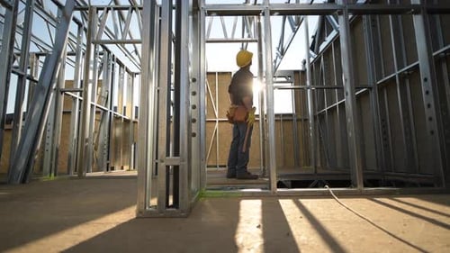 Construction Worker Inspecting New House Steel Frame