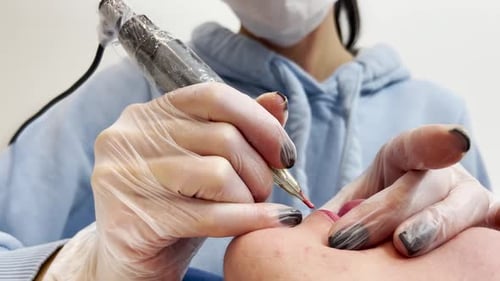 Cosmetician Giving Client Lip Blushing Treatment