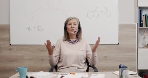 Woman with Headset Teaching Chemistry Online