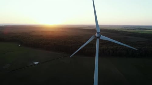 Wind Turbine at Sunset Generates Clean Energy