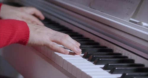 Hands Play Piano Keyboard in Close-Up