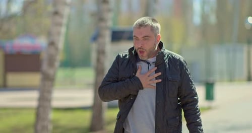 Man with a Coughing Fit and Shortness of Breath is Walking Along the Street a Man Has an Attack of