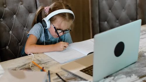 Child Learning Online at Home with Laptop