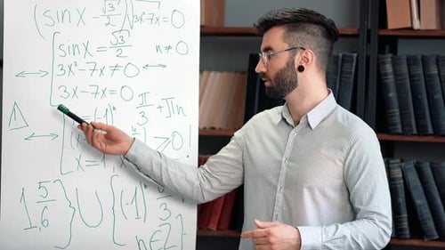 Male Teacher Talking Explaining Giving Presentation Conference Mathematical Formula on Whiteboard