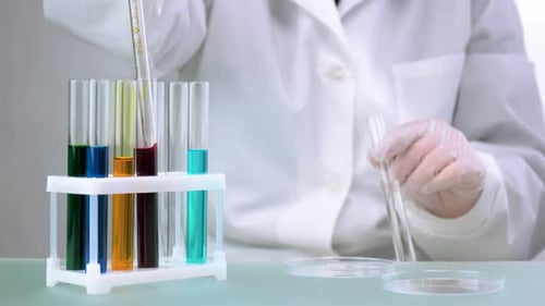 Scientist Using Pipette to Transfer Red Fluid