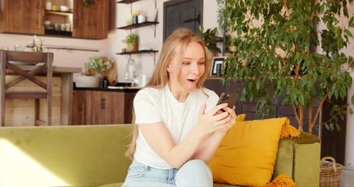 Woman Excited After Receiving Good News on Phone