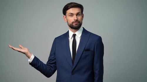 Man In Suit Presenting With Palm Open