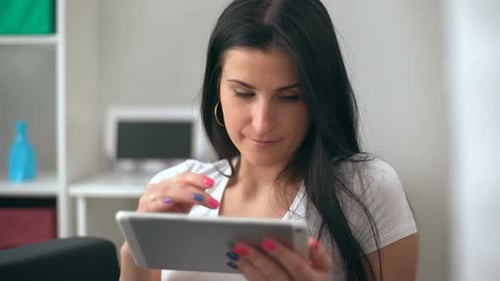Young Woman Interacts with Tablet Device