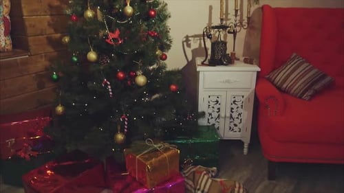 View of Christmas Decorated Room with Pine Tree and Presents Under It