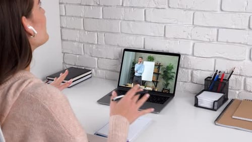 Young Adult Woman Having Online Meeting with Colleague