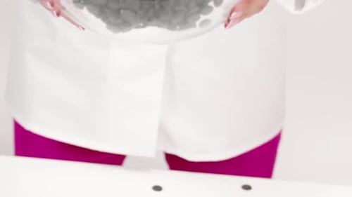 Pouring Chocolate Chips from Bowl in Close Up