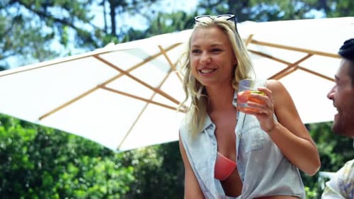 Friends Laughing and Socializing Outdoors on Sunny Day
