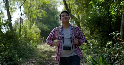 Young Man walking in Forest trail with Hiking concept